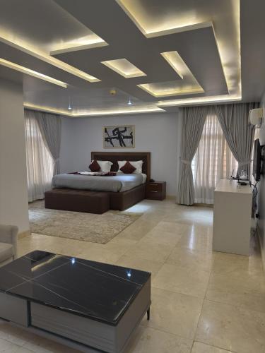 a living room with a bed and a coffee table at Glovis Suites in Abuja