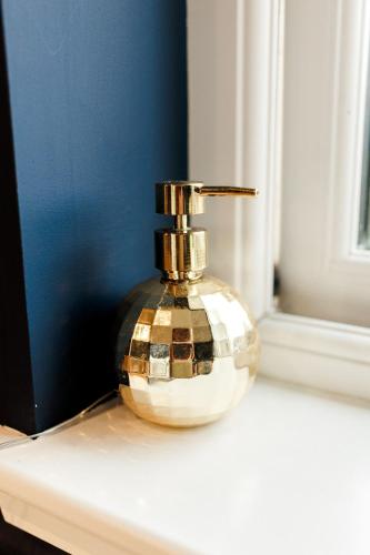 a perfume bottle sitting on a window sill at Annabelle's Den in Gatehouse of Fleet