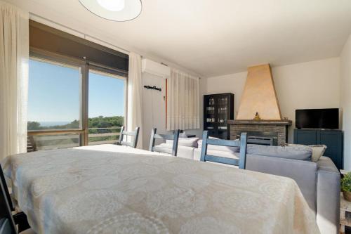 a bedroom with a large bed and a couch at Mima House with Pool in Canyelles