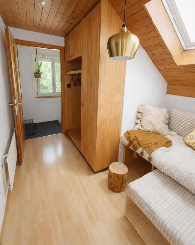 a small room with a bed and a window at Quiet Forest-Side Apartment in Flamatt