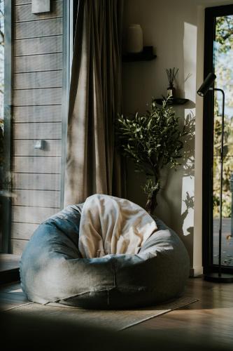a dog bed sitting on the floor in a room at Lake Forest Kabin in Bárdudvarnok