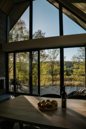 a plate of fruit on a table in front of a window at Lake Forest Kabin in Bárdudvarnok