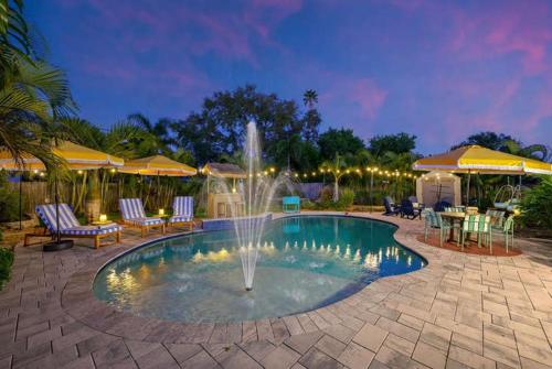 a fountain in the middle of a swimming pool at Resort Style Backyard Pool Hot Tub Games in Seminole