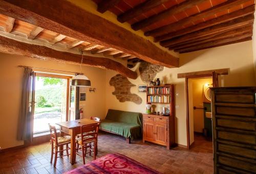 a living room with a table and a couch at Romantic stone farmhouse studios with private terrace in beautiful Tuscany in Subbiano