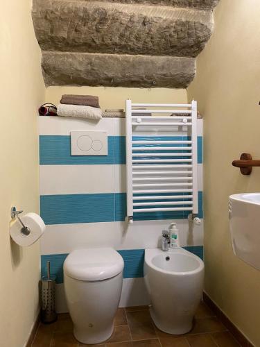 a bathroom with a white toilet and a sink at Romantic stone farmhouse studios with private terrace in beautiful Tuscany in Subbiano