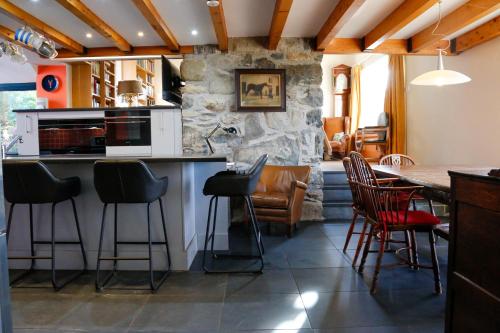 a kitchen with a table and some chairs at Ty Uchaf in Colwyn Bay
