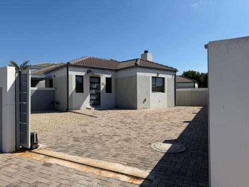a large white house with a driveway at 17 On Sleigh in Langebaan
