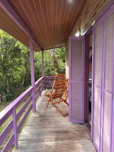 a purple porch with a bench on it at Pousada da Chacara in Nova Petrópolis