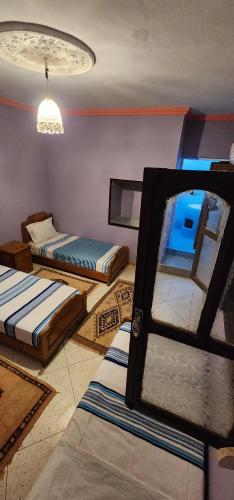 a room with two beds and a window at Ighbola Ouzoud in Ouzoud