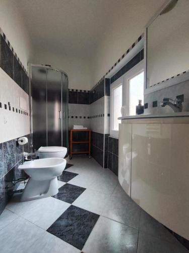a bathroom with a toilet and a shower and a sink at Margherita in Seriate