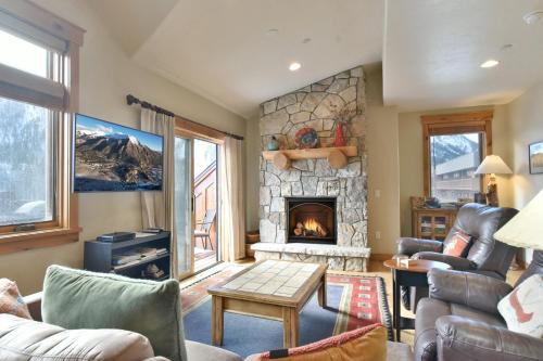 a living room with a fireplace and a couch at Mt. Victoria Lodge Penthouse Condo: Downtown, Hot Tub in Frisco