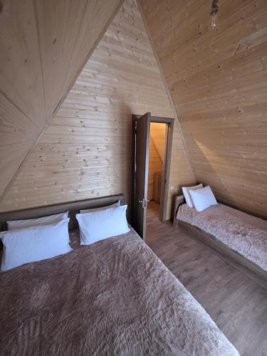 a bedroom with a bed in a wooden wall at Chalet Gudauri in Gudauri