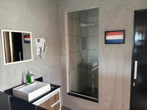 a bathroom with a sink and a shower at Amsterdam Lofts Deluxe in Poços de Caldas