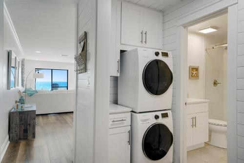 a white bathroom with two washer and dryer at Dune Villas 2A - Gulf Front Vacation Condominium with Shared Pool in Santa Rosa Beach