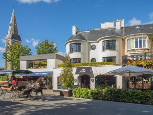 a horse drawn carriage in front of a building at The Ross in Killarney