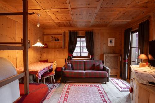 a living room with a couch and a table at Apartments Mauriz in Selva di Val Gardena