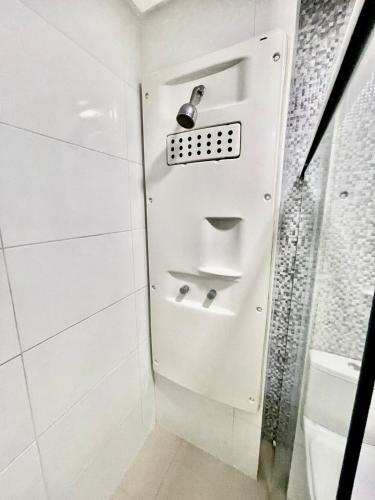 a shower stall with a door in a bathroom at Studio Cafe duas camas de solteiro in Arapiraca
