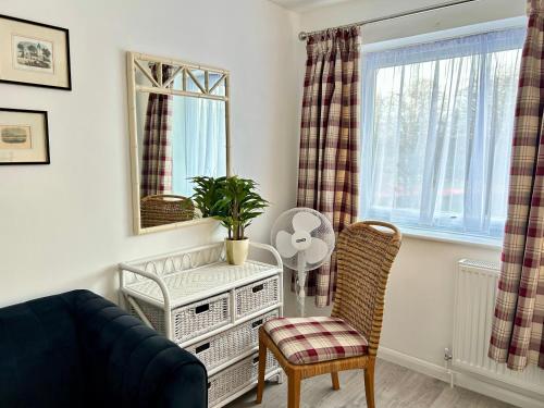 a living room with a couch and a chair and a mirror at Victory Gate 3 double bed House in Old Portsmouth Parking Pets in Portsmouth