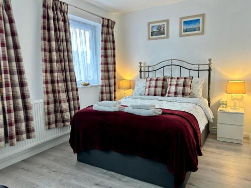 a bedroom with a bed with two towels on it at Victory Gate 3 double bed House in Old Portsmouth Parking Pets in Portsmouth