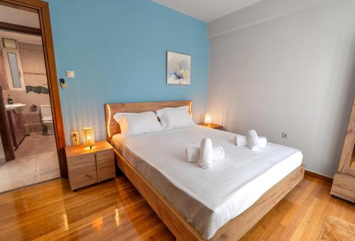a bedroom with a bed with white sheets and towels at Zeas Yacht View in Piraeus