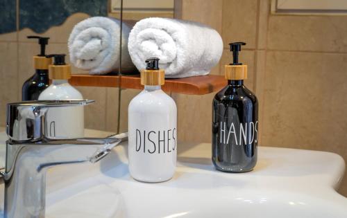 two bottles of disinfectants sitting on a bathroom sink at Zeas Yacht View in Piraeus
