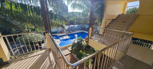 a balcony with a view of a swimming pool at Baan Nokkamin Seaside in Hua Hin - บ้านนกขมิ้นซีไซด์ หัวหิน in Hua Hin
