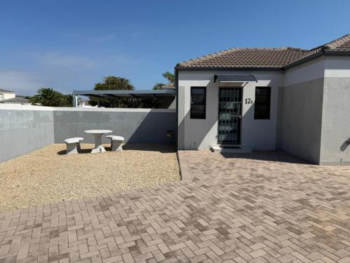 a house with a patio with a table in front of it at 17 On Sleigh in Langebaan