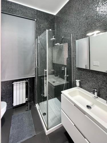 a bathroom with a shower and a sink and a toilet at The Superhost - Duomo Apt in Crotone