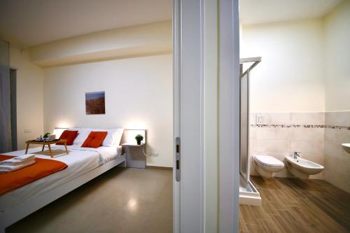 a bedroom with a bed and a sink and a toilet at Ètoile Palace Gravina in Gravina in Puglia