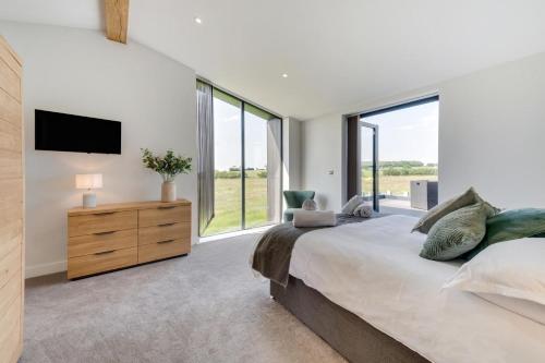 a bedroom with a large bed and a large window at 4 Bed in Crosby oc-b31135 in Northallerton