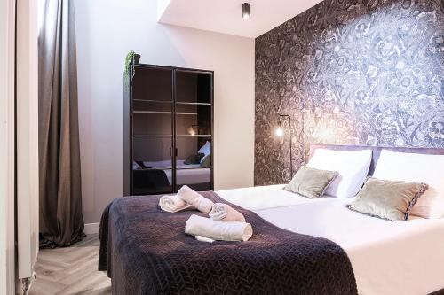 a bedroom with two beds with towels on the bed at Stylish city center villa tilburg in Tilburg