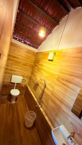 a bathroom with a toilet and a sink at Qatsyir Horizon in Varagampadi