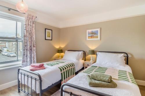 two beds in a room with a window at 2 Bed in Pakefield oc-p32922 in Lowestoft