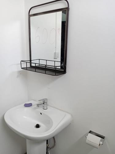 a bathroom with a sink and a mirror on the wall at Quiet corner ideal for holidays in Centre de Flacq