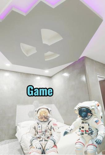two astronauts in a room with the words game at Hoft Hotel Ramkhamhaeng24 in Sathani Khlong Tan