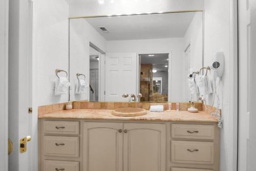 a bathroom with a sink and a large mirror at Buena Vida 23 in Navarre