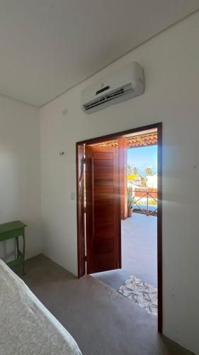 a room with a door leading to a patio at Casa Dunas Baleia in Itapipoca