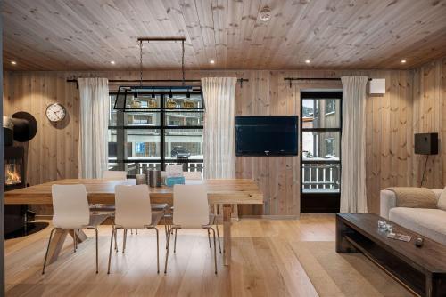 a dining room with a table and chairs at TT28- Ski-in out apartment in Trysil turistcenter with sauna in Trysil