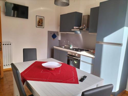 a kitchen with a table with a red napkin on it at La Quiete appartamento in campagna a Spoleto in Spoleto