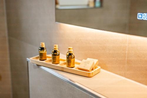 three bottles of essential oils on a shelf in a bathroom at Diamond Deluxe in Ludwigshafen am Rhein
