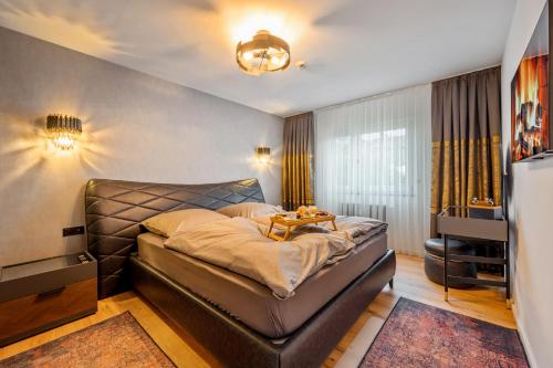 a bedroom with a bed with a table on it at Diamond Deluxe in Ludwigshafen am Rhein