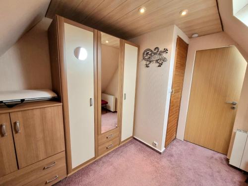 a small room with a bed and a mirror at Schnuckelchen in Marl 2 in Marl