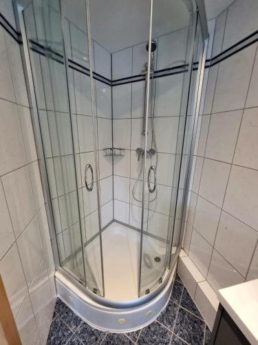 a shower with a glass door in a bathroom at Schnuckelchen in Marl 2 in Marl