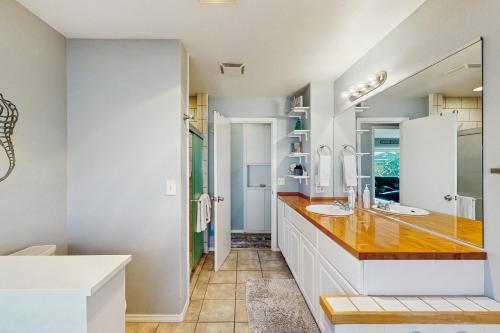 a bathroom with two sinks and a large mirror at Ocean View Retreat in Brookings