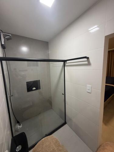 a shower stall with a glass door in a room at Duplex Coité in Conceição do Coité
