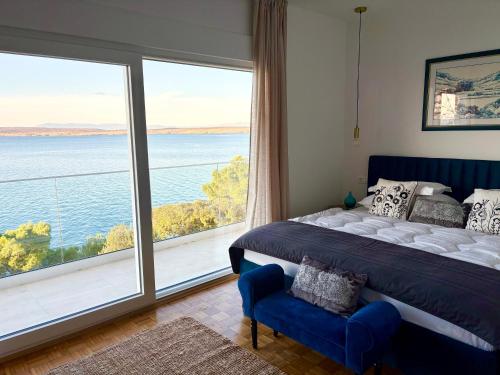 a bedroom with a bed and a large window at Villa Empress in Dramalj