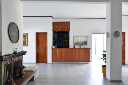 a living room with white walls and a wooden door at Hotel Melikari in Skiros