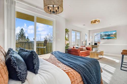 a bedroom with a bed and a living room at The Revive Loft with Balcony, Workspace and Bikes in Fort Collins
