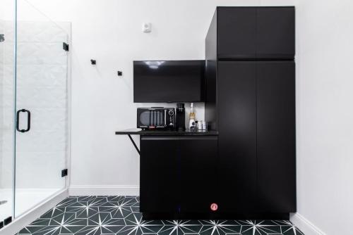 a kitchen with a black refrigerator and a microwave at Hollyhock Suite 409 in Louisville