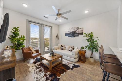 a living room with a couch and a table at The Stockyard Retreat - Pool, Gym & Free Parking in Fort Worth